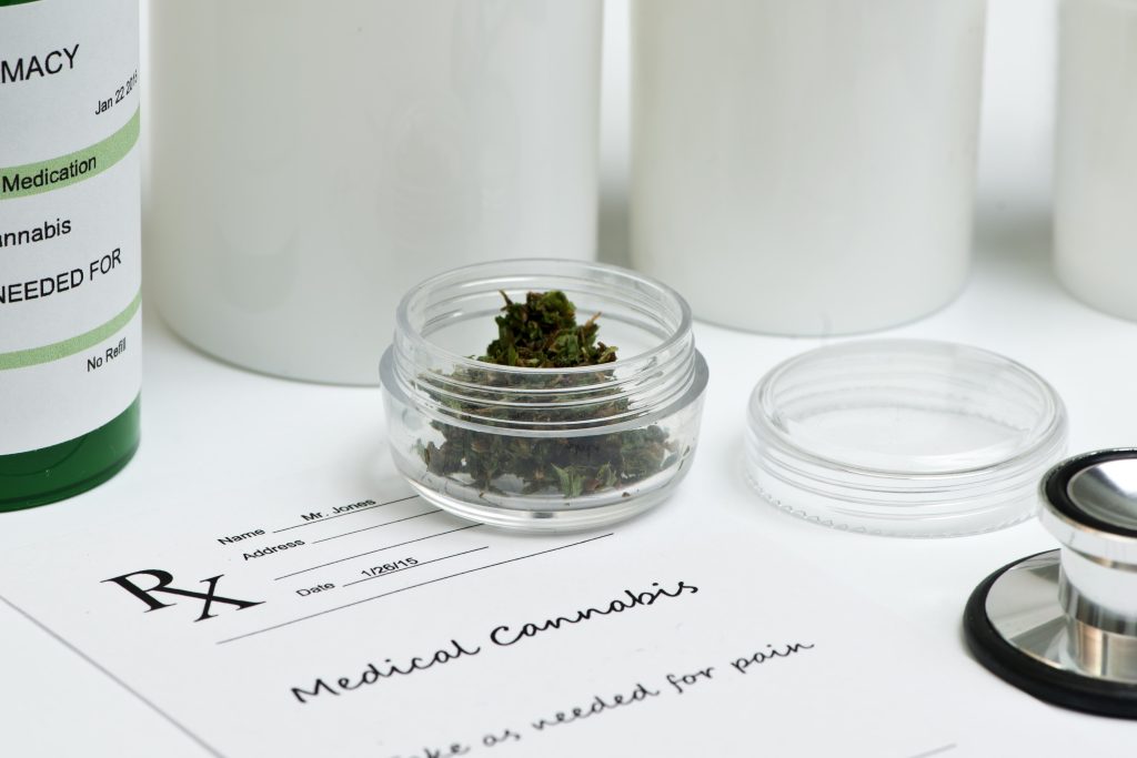 cannabis bud in jar on rx script