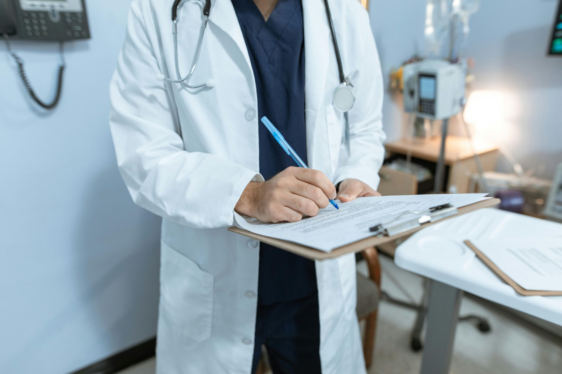 Doctor Writing on a Medical Chart. medical marijuana conditions
